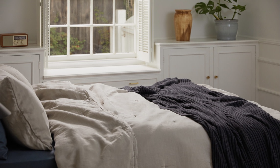 made bed with throw blanket 